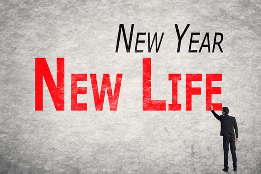 Asian business man write words on wall, New Year New Life
