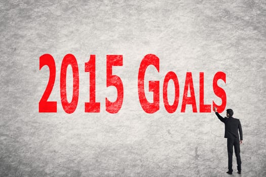 Asian business man write words on wall, 2015 Goals