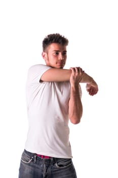 Handsome young man or teenager stretching arm and shoulder, isolated on white