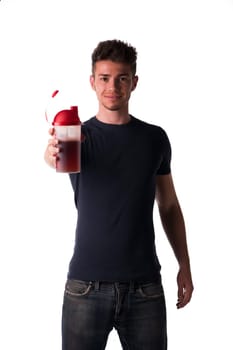 Attractive young man or teenager holding protein shake bottle. Isolated on white, smiling and looking at camera