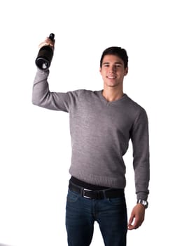 Handsome young man holding bottle of champagne or sparkling white wine, isolated on white
