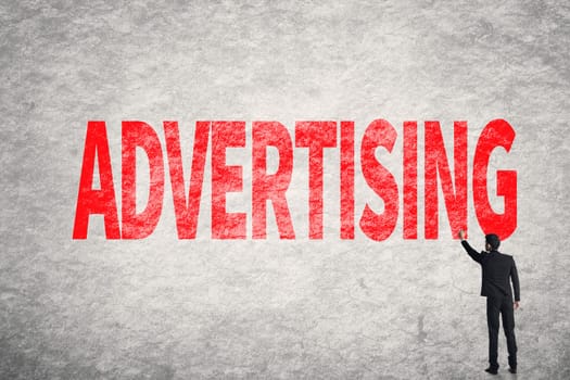 Asian business man write words on wall, Advertising