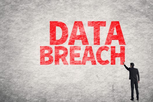 Asian business man write words on wall, Data Breach