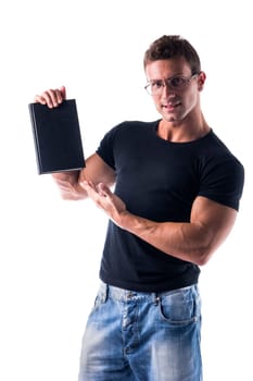 Smiling young man wearing glasses  holding and showing book cover, isolated on white