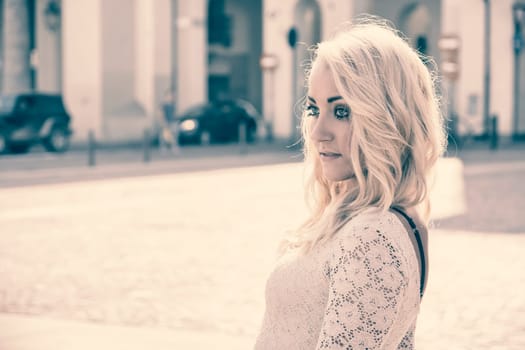 Pretty Young Blonde Woman in Sexy White Dress in Turin City Center, Italy. Captured with Buildings at the Back.