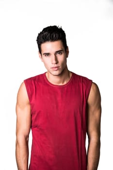 Handsome young man isolated on white background looking at camera with serious, confident expression