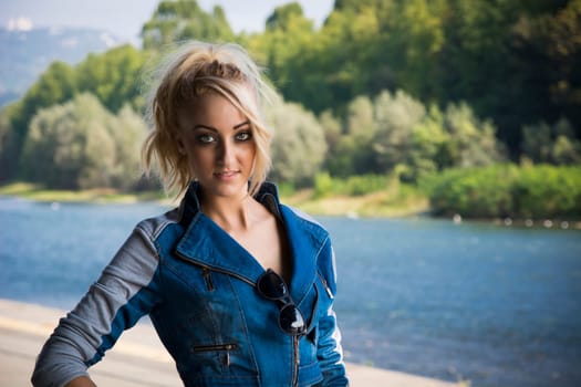 Young Pretty Blond Woman in Trendy Denim Fashion Outdoor Next to River and Park
