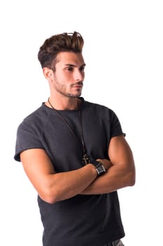 Fit handsome young man standing confident in casual clothes, looking away isolated on white