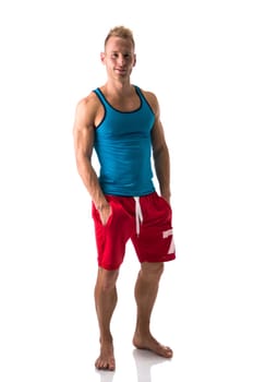 Full figure of muscular, young man standing confident barefeet, smiling at camera isolated on white