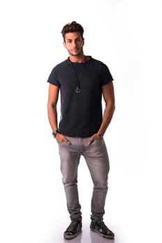 Full figure of handsome young man standing confident in casual clothes, looking at camera isolated on white