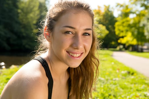 Portrait of young smiling  sporty woman, outdoors
