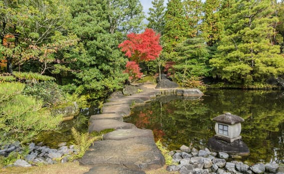 Autumn scenery with red maple trees and pond of Kokoen garden in Himeji, Japan