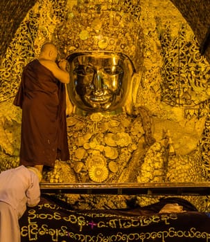 The ritual of daily face washing Mahamuni Buddha in Mandalay, Myanmar