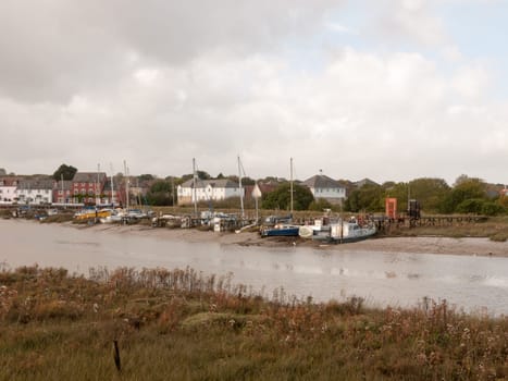 row of moored private boats in estuary autumn day  essex  england  uk