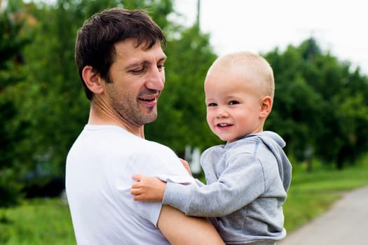 Happy family, uncle and boy on green background.