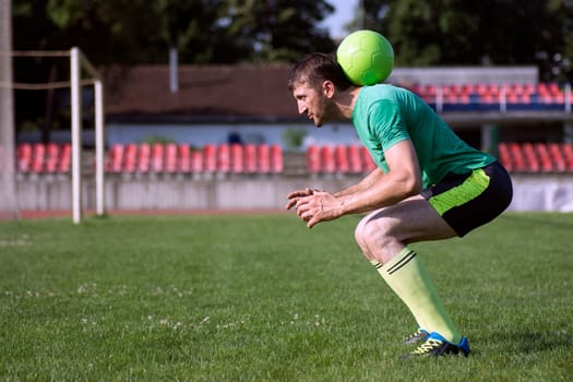 The football player holds the ball on his neck.