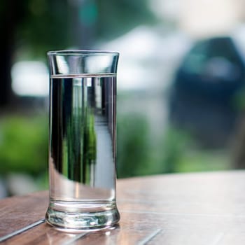 Water in drinking glass is on the table.