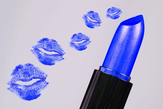 Blue lipstick and blue lipstick kisses are on gray background.