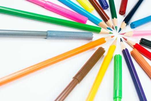 Colorful wooden pencils and felt pens on white background.