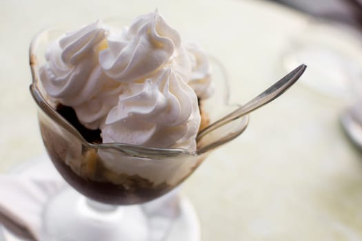 Traditional Hungarian dessert, somloi galuska, with whipped cream.