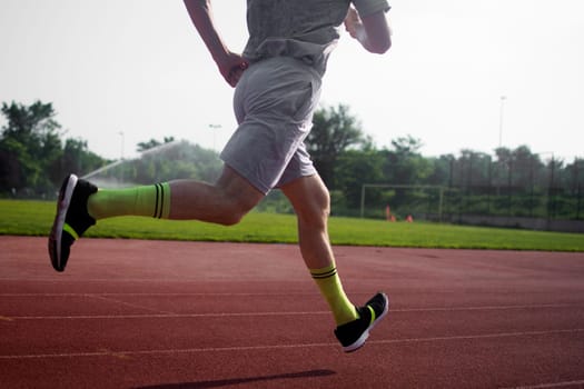 The athlete is running in the stadium.