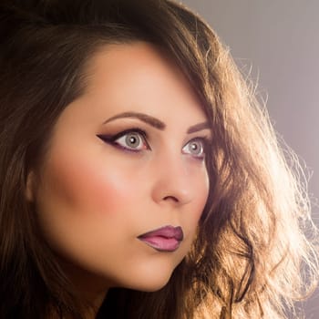 Beauty portrait about woman with purple make-up.