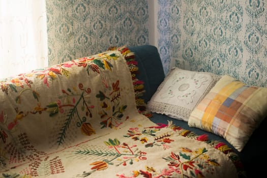 Old village room with bed and vintage patterns on the wall.
