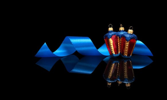 Christmas card template in luxury style, premium. Three Christmas decorations lantern with blue ribbon isolated on a black glossy background with real reflection. With space for your text