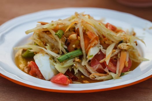 SOM-TAM, Thai delicious raw papaya salad with unique taste hot and spicy, this dish with tomato and crab.
