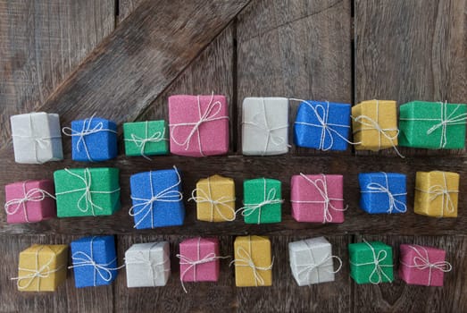 Small colorful gifts in glitter wrapping paper for Christmas