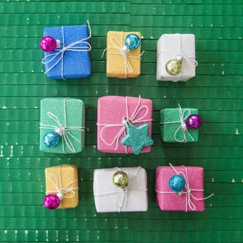Small colorful gifts in glitter wrapping paper for Christmas