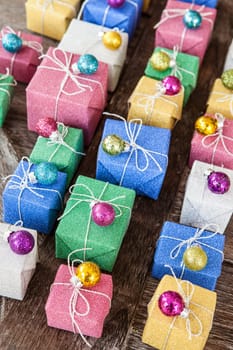 Small colorful gifts in glitter wrapping paper for Christmas