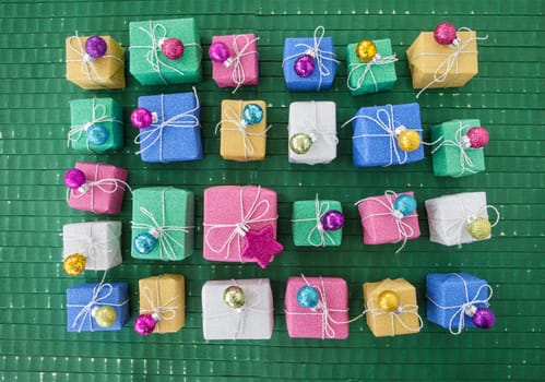 Small colorful gifts in glitter wrapping paper for Christmas