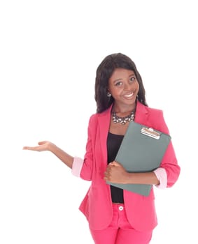 A lovely young woman in a pink suit, holding a folder, with one hand.outstretched gesture welcome, isolated for white background.