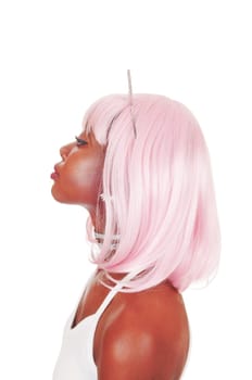A lovely serious young African woman with pink hair and silver bunny.ears in a closeup portrait image, isolated for white background.