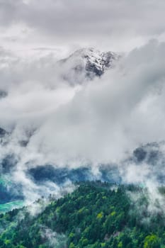 Snowy Peak of Mountain Range in Clouds