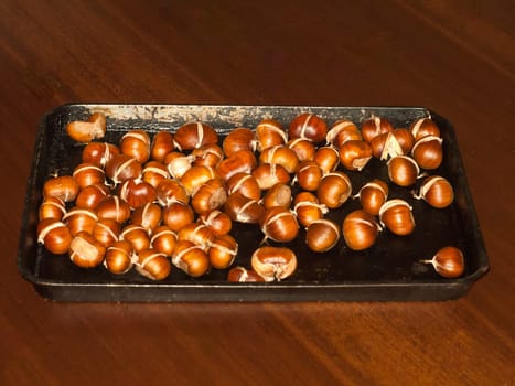 tray of freshly cooked roasted chestnuts autumn forage food kitchen home  essex  england  uk