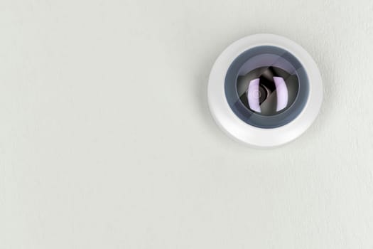 Bottom view of cctv camera on white ceiling