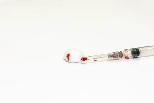 red blood syringe isolated on white background, selective focus