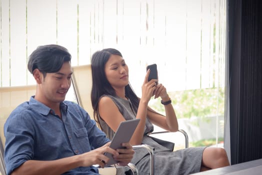 beautiful young asian business woman using smartphone in office, selective focus