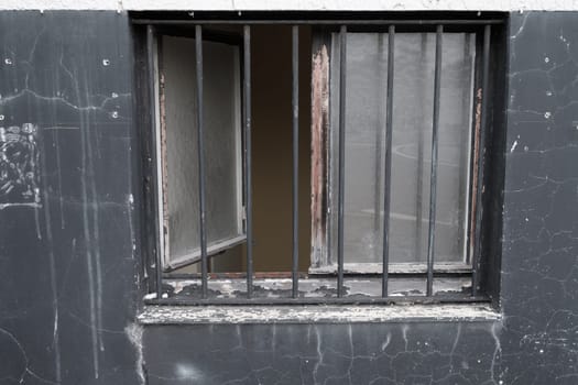 Weathered wall with window open and lattice