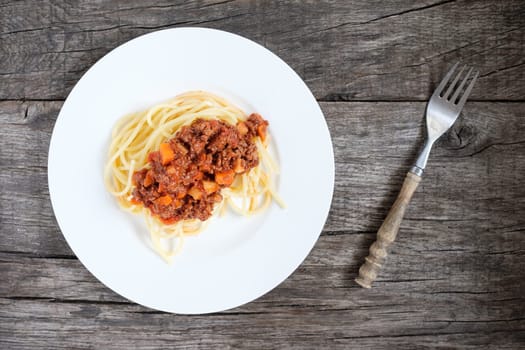 Spaghetthi with Bolognese sauce on rustic table