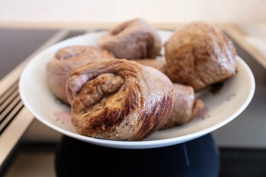 Roulade of beef fried on plate and stove