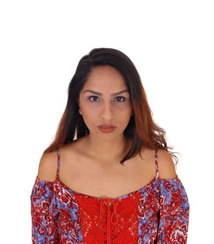 A closeup portrait image of a brunette woman in a colorful top, looking.serious from the front, isolated for white background.