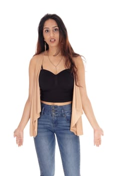 A beautiful young woman standing in jeans and a black corset with.brunette hair and necklace, isolated for white background.
