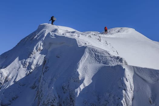 climbing on mountain in winter. Piatra Craiului Mountains, Romania