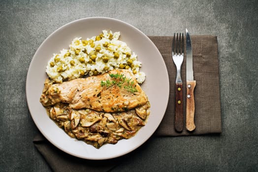 Roasted chicken steak with stir fry mushroom sauce and rice with pea