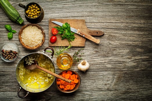 Ingredients for cooking fresh risotto meal on wooden background.