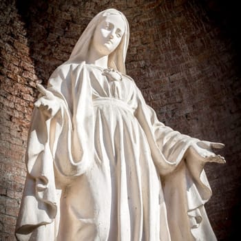 Close-up of Our Lady with open arms, bottom view.