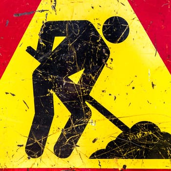 One sign of attention, road works. The sign is old, worn out.